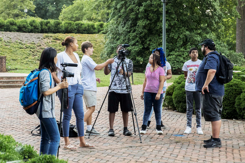 Local youth volunteers work with a Light House Studio film crew to capture a vignette of a traffic stop.