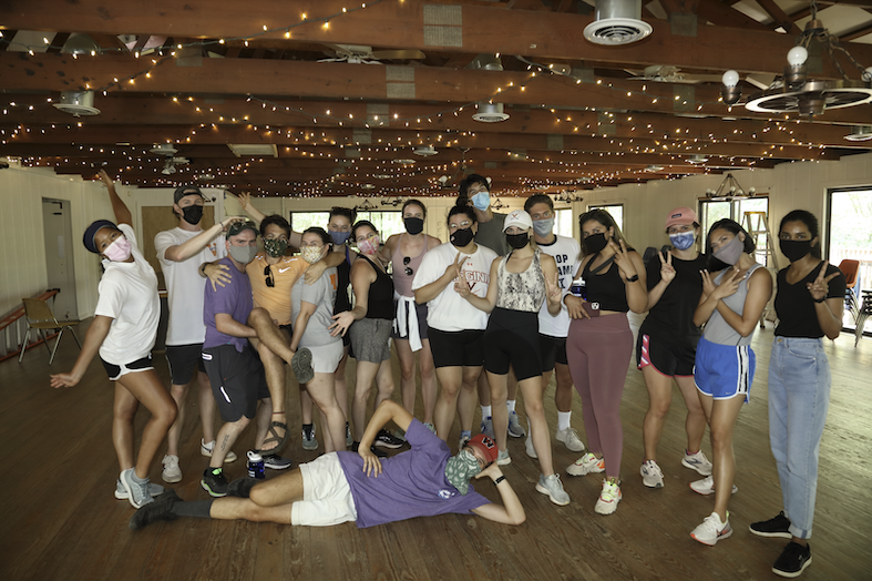 Student volunteers pose under the lights they used to decorate the dining hall at Camp Holiday Trails, a year-round camp for children with medical needs. 