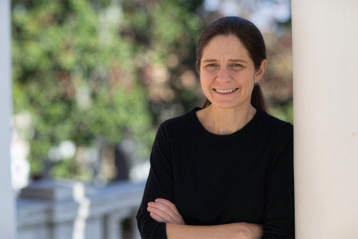 Portrait of Sarah Turner, arms crossed and smiling
