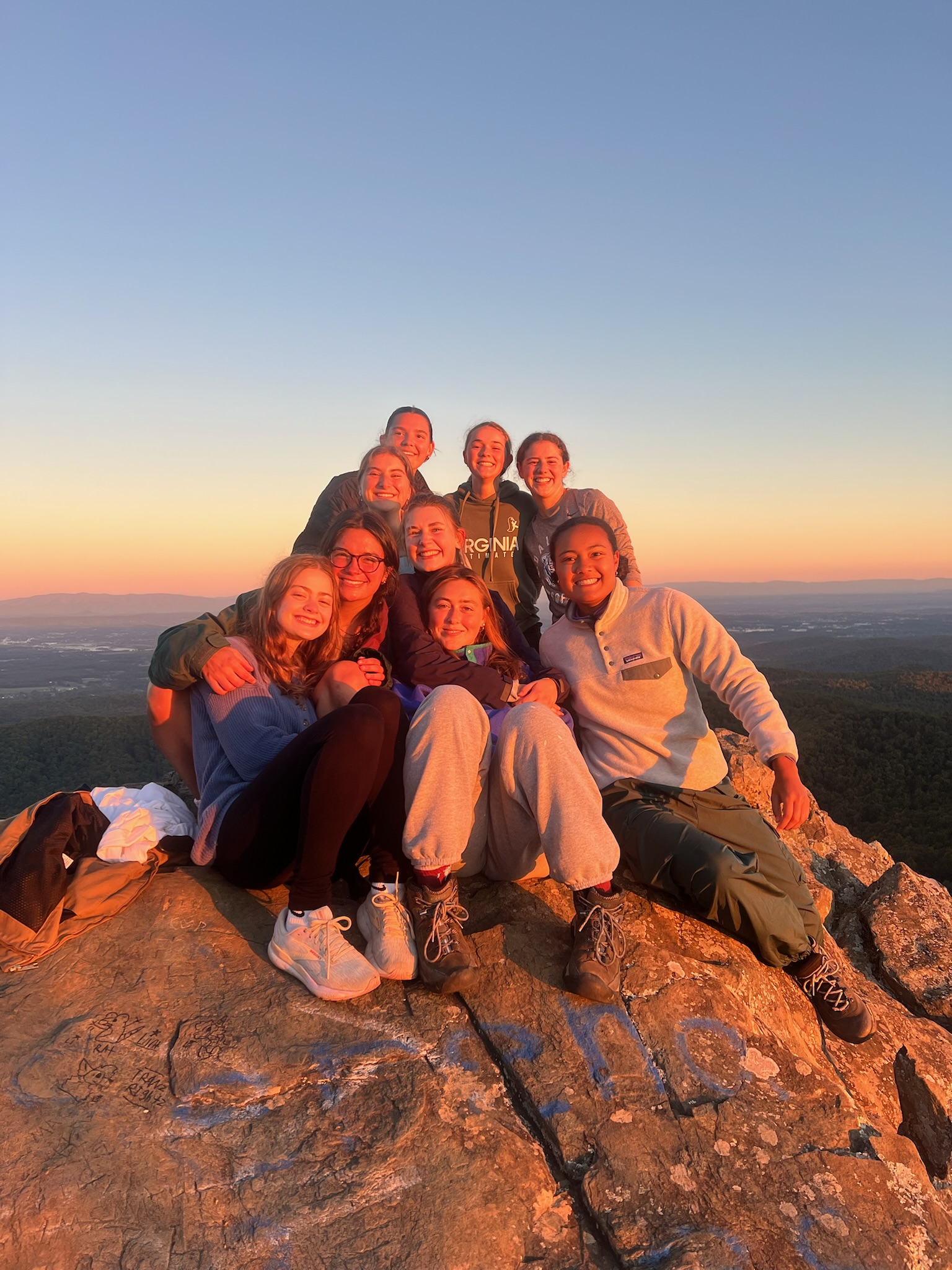 UVA Hydra teammates pose at the top of Humpback Rocks mountain after a hike at sunrise